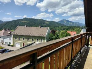 a balcony with a view of a town and mountains at sechzehnerhaus in Mariazell