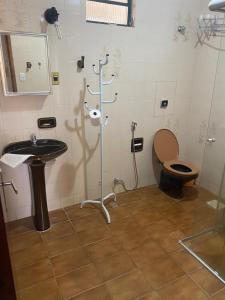 a bathroom with a toilet and a sink at Chalés Holiday House in Rio Quente