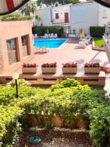 a patio with threeotted plants and a swimming pool at baiasole in Sanremo