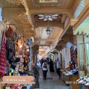 a group of people walking through a market with shops at Maison l'océan in Rabat