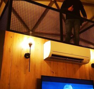 a person standing on top of a balcony with a tv at In out superior glamping in Antalya