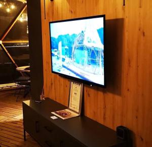 a flat screen tv on a wooden wall at In out superior glamping in Antalya