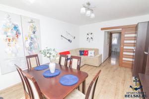 a dining room with a table with blue plates on it at Apartament Helski in Hel