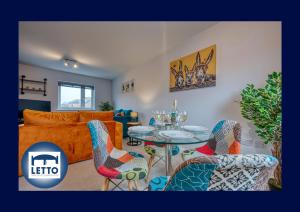 a living room with a table and chairs and a couch at Letto Serviced Accommodation Peterborough - Oakcroft House - PE7 FREE Parking in Peterborough