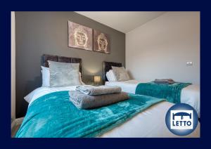a bedroom with two beds with green and white sheets at Letto Serviced Accommodation Peterborough - Oakcroft House - PE7 FREE Parking in Peterborough