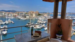 a balcony with a view of a marina with boats at Boutique Apartment Hirondelle Port Frejus in Fréjus