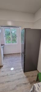 an empty room with a refrigerator in a room with windows at Marear in Porto Santo