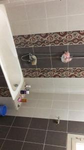 a bathroom with a shower and a tile floor at شقة مفروشة in Mansoura