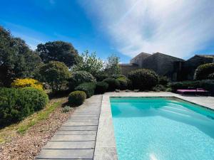 uma piscina num jardim ao lado de uma casa em La Gardette, Gordes, vue panoramique Ventoux em Gordes