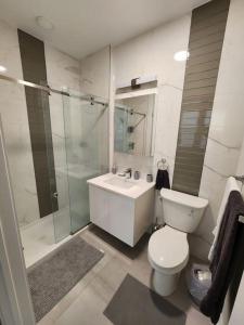 a bathroom with a toilet and a sink and a shower at Close to NYC, 10 Guest, Luxurious 3Bedroom Apartment in Union City