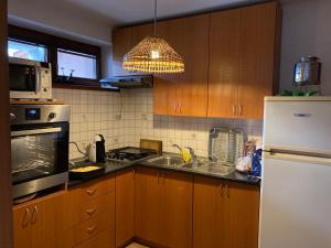 a kitchen with wooden cabinets and a white refrigerator at U starkych in Poprad