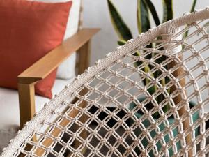 a rattan chair next to a plant at Madeira Breeze in Funchal