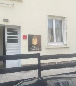 a sign on the side of a building with a window at Bienvenu à l’appart bien-être in Souvigny