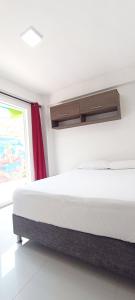 a bed in a room with a window at Apartamentos sophia in San Andrés