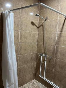 a shower with a shower curtain in a bathroom at HamEl Guest House in Odzun +49 photos
