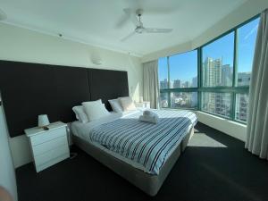 a bedroom with a large bed and a large window at Crown Towers in Gold Coast