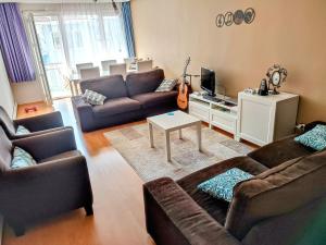 a living room with two couches and a guitar at USKUDAR Home in Istanbul