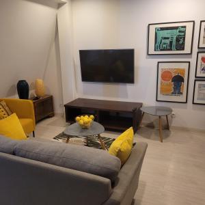 a living room with a couch and a flat screen tv at Apartamenty Batorego 4 in Bydgoszcz