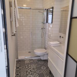 a bathroom with a shower and a toilet and a sink at Apartamenty Batorego 4 in Bydgoszcz +15 photos