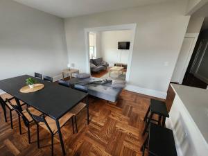 a living room with a table and chairs and a couch at Elegant 2 bed gem! mins from NYC in Union City
