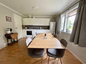 a dining room with a wooden table and chairs at Leknes City Apartment in Leknes