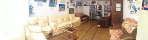 a living room with a white couch and a table at Naty's Guest House in Cusco