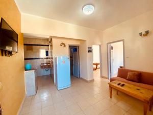 a living room with a couch and a blue refrigerator at A5ena House in Dahab