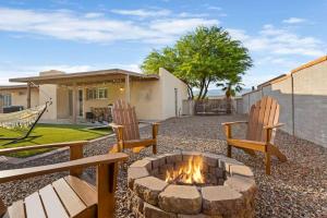 a backyard with two chairs and a fire pit at Pool, Fire Pit, Ping-Pong in Tucson