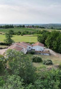 an aerial view of a farm with buildings and trees at Trespouz'en in Trespoux-Rassiels