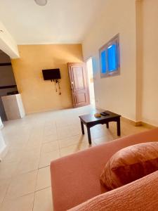 a living room with a couch and a table at A5ena House in Dahab