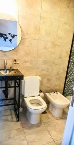 a bathroom with a toilet and a sink at Alsina Suite!! Hermoso y moderno apart en Salta!! in Salta