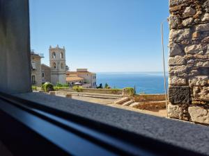 a view of the ocean from a window of a building at The White Domus in Taormina
