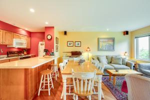a kitchen and living room with a couch and a table at Burke Mountain Vacation Rental Ski-In and Ski-Out! in East Burke