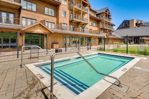 a swimming pool in front of a building at Burke Mountain Vacation Rental Ski-In and Ski-Out! in East Burke