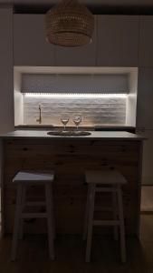 a kitchen with two wine glasses sitting on a counter at Apartament&SPA Lis&Las in Sobótka