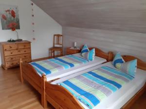 a bedroom with two beds with blue and white pillows at Ferienwohnung-Christa-Salem in Salem