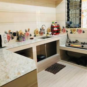 a kitchen with a sink and a counter top at Modern 3 Bedroom Flat in Sylhet in Sylhet