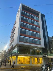 a hotel building with people walking in front of it at HVH by Yaxché in Guadalajara