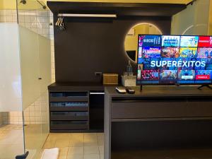 a television on a counter in a room at Casa Charlotte - Alma Hotels in Santa Marta