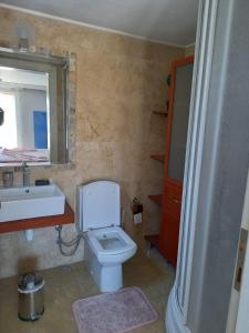 a bathroom with a toilet and a sink and a mirror at Вилла in Belek
