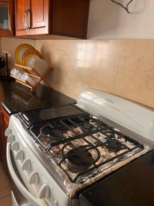 a white stove top oven in a kitchen at Villa ML in Los Mameyes