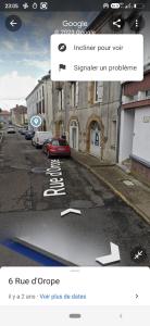 a screenshot of a street with a car parked on the road at La Pierre n°3 en Centre Ville in Tartas