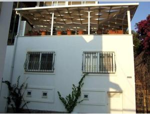 a white building with two windows and a roof at House near Marina, Yachts, Boats. 4,5 BR in Torba