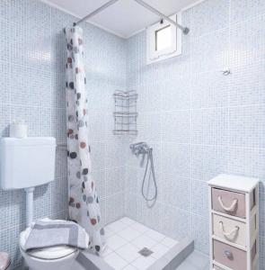 a bathroom with a shower with a toilet and a sink at Katerina’s Lux Home in Gerokampos Beach