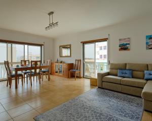 a living room with a couch and a table at Alojamento Santo António II in Nazaré
