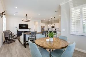 a dining room and living room with a table and chairs at Goodyear Vacation Rental with Private Hot Tub in Goodyear