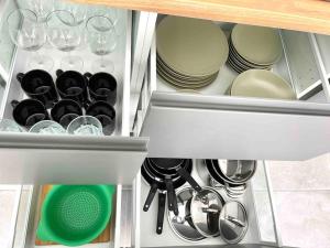 a drawer in a kitchen with dishes and wine glasses at Weybeach 7 - New, modern, stylish, fully equipped in La Santa