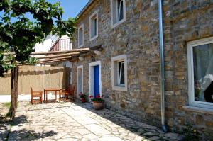 a stone house with a table and chairs outside at Istrian House in Portorož