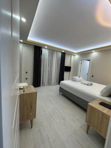 a large room with a bed and a desk and a bed sidx sidx sidx at Villa mila in Belek