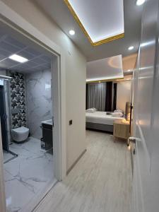 a room with a bathroom with a bed and a door at Villa mila in Belek